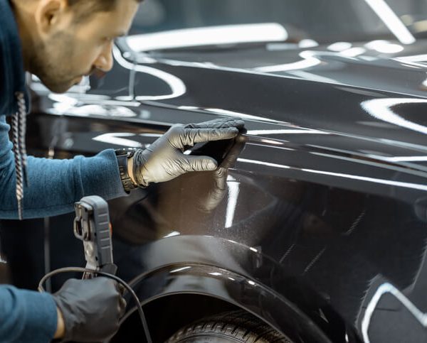 Auto body mechanic at work after auto body training