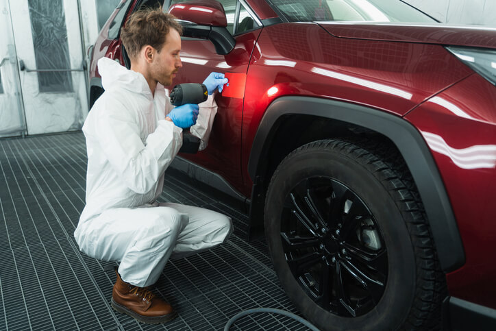 Student in auto body training checking for colour match