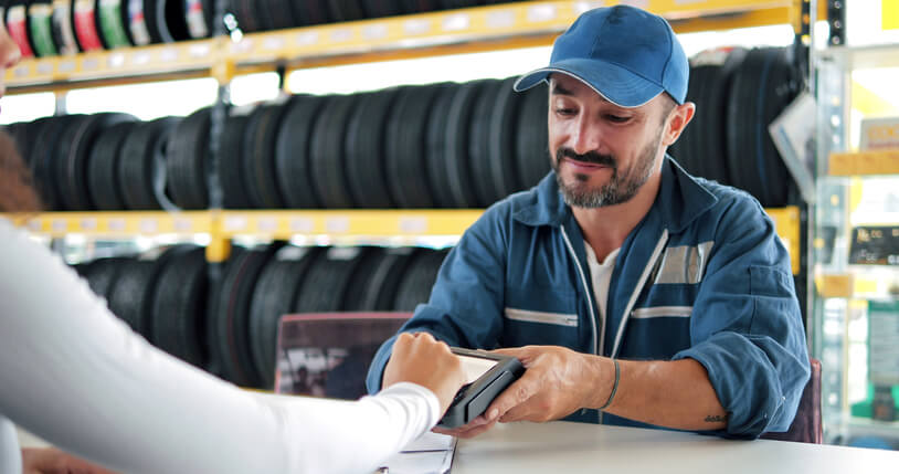 Smiling auto parts specialist talking with a customer after auto parts training.