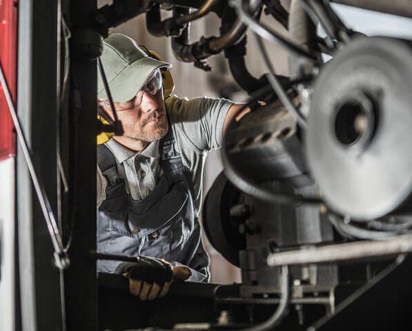 A mechanic working on a diesel engine after diesel mechanic training