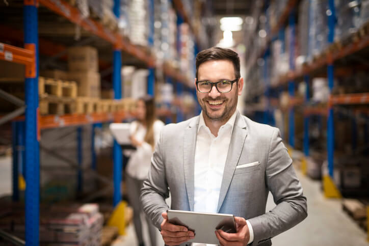 A confident and successful male dispatcher at a warehouse after dispatch training