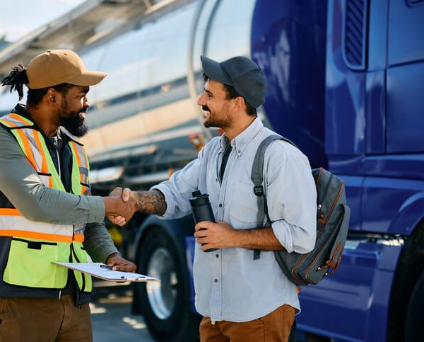 A smiling dispatcher interacting with a driver after dispatch training