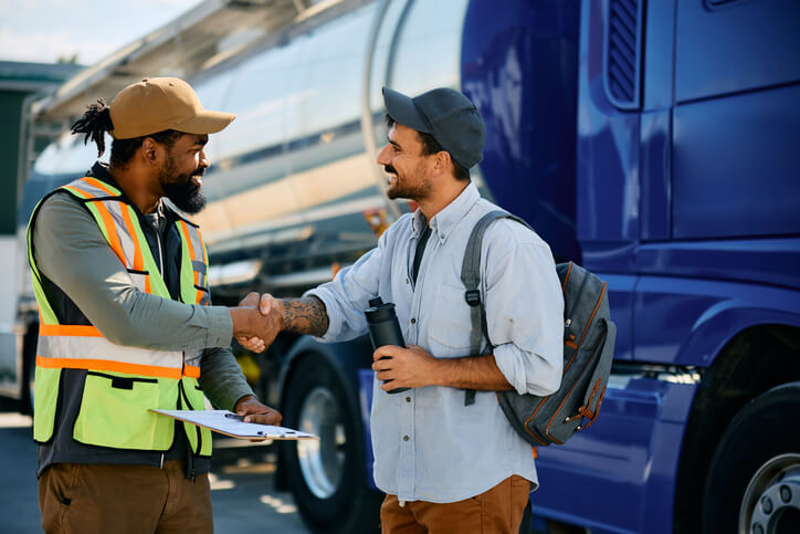 A smiling dispatcher interacting with a driver after dispatch training