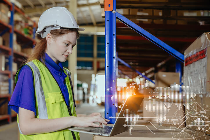 A female log book auditor checking inventory in a futuristic warehouse