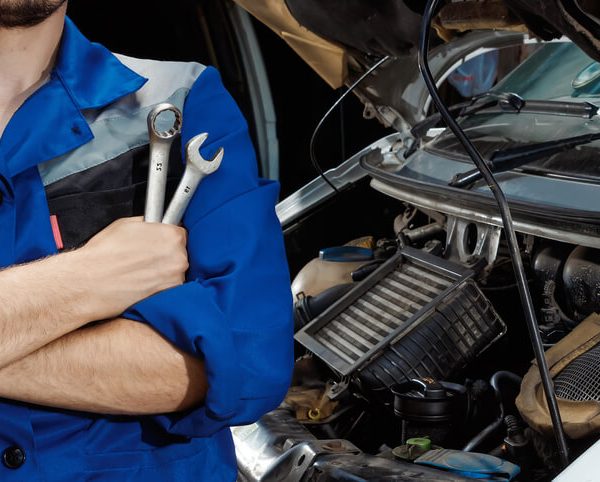 A male auto mechanic at a garage after completing his auto mechanic training