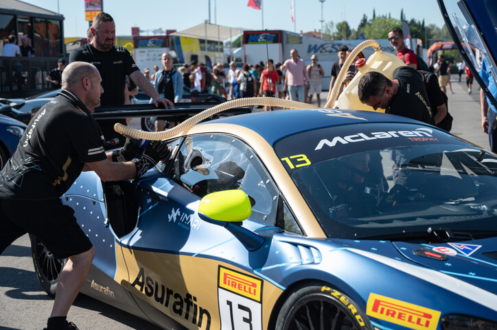 A male race car mechanic checking a high-performance vehicle after completing his auto mechanic training