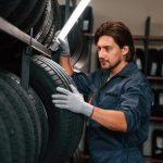 An auto parts training grad managing inventory in a tire warehouse